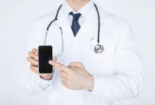 Doctor pointing at smartphone — Stock Photo, Image