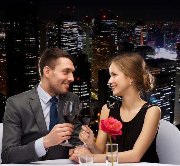 Jeune couple avec des verres de vin au restaurant — Photo