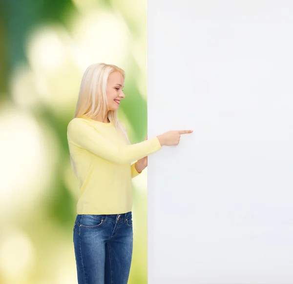 Smiling woman in sweater with blank white board — Stock Photo, Image