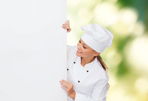 Chef feminino sorridente com placa branca em branco — Fotografia de Stock