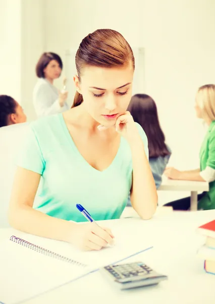 Student girl with notebook and calculator Stock Photo