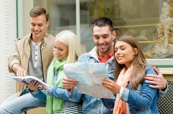 group of friends with guide and map exploring town