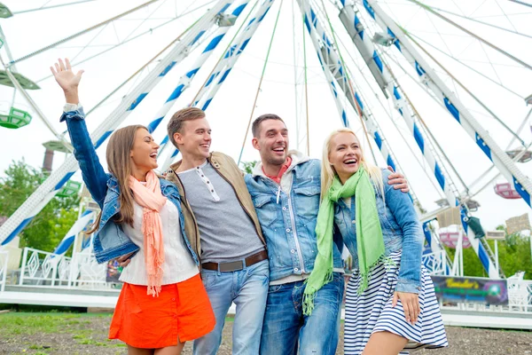 Group of smiling friends waving hands — Stock Photo, Image