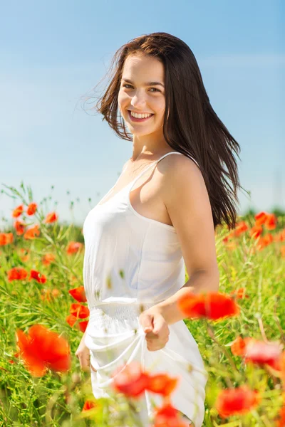 Sorrindo jovem mulher no campo de papoula — Fotografia de Stock