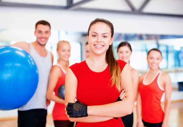 Woman standing in front of the group in gym Stock Image
