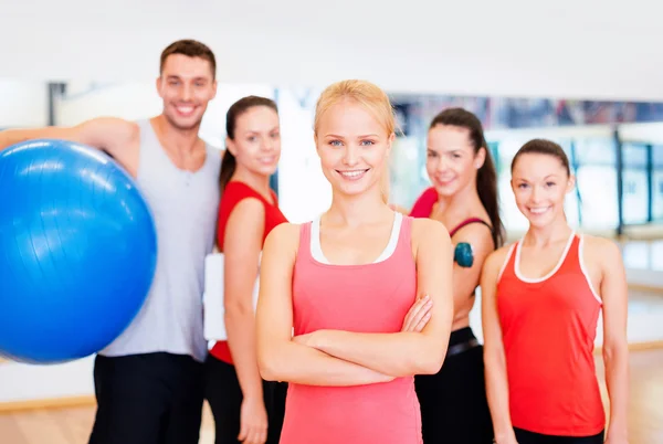 Woman standing in front of the group in gym Stock Photo