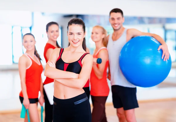 Woman standing in front of the group in gym Stock Picture