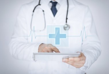 male doctor holding tablet pc with medical app clipart