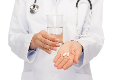 close up of doctor offering pills and water clipart