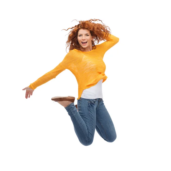 Smiling young woman jumping in air — Stock Photo, Image