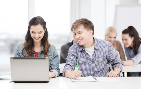 Students with laptop and notebooks at school — Stock Photo, Image