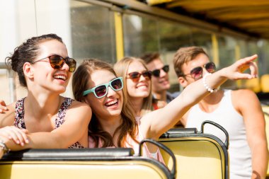 group of smiling friends traveling by tour bus clipart