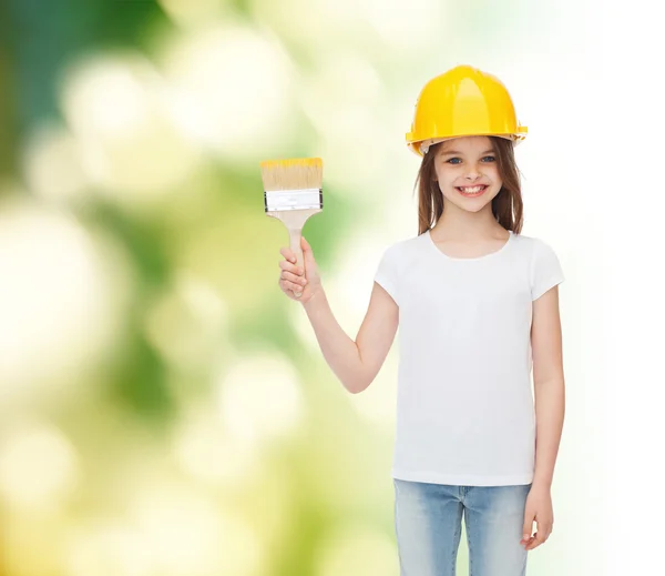 Smiling little girl in helmet with paint brush — Stock Photo, Image