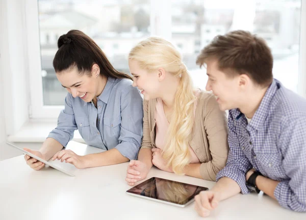 Smiling students with tablet pc computer at school — Stock Photo, Image