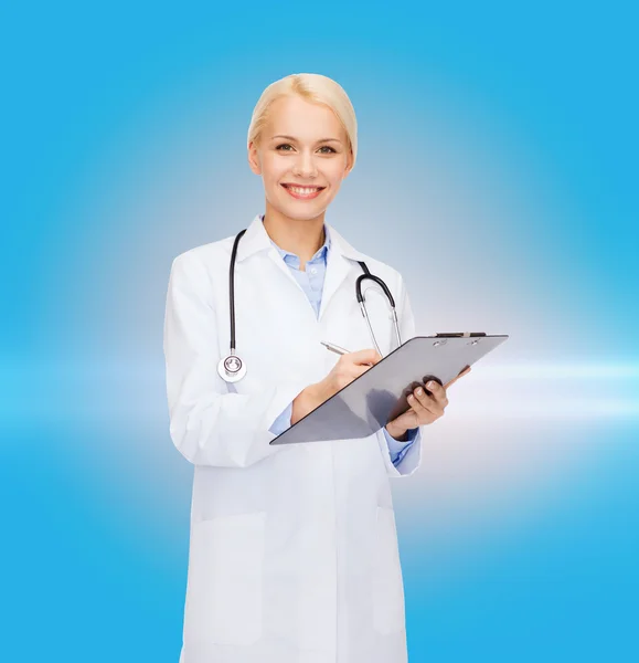 Smiling female doctor with clipboard — Stock Photo, Image