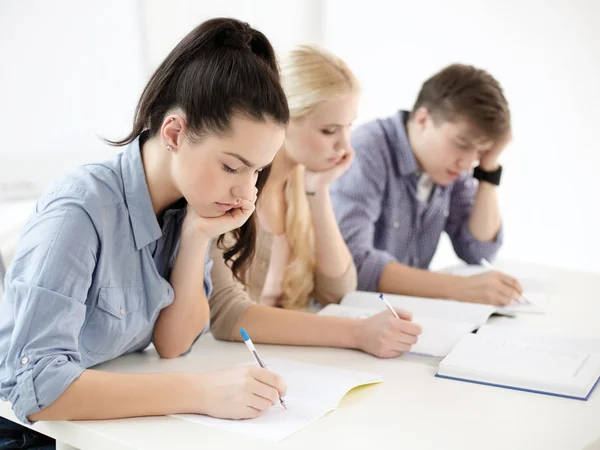 Tired students with notebooks at school Stock Picture