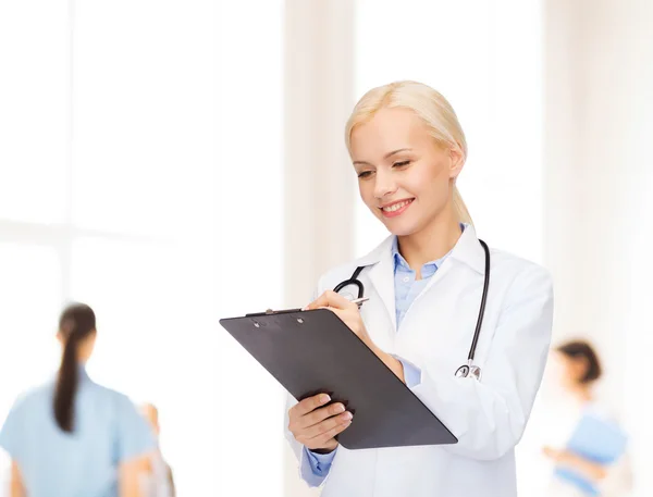 Smiling female doctor with clipboard Stock Photo