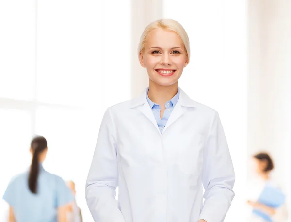Smiling female doctor with group of medics — Stock Photo, Image