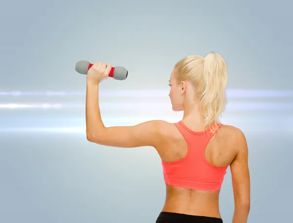 Young sporty woman with light dumbbell — Stock Photo, Image