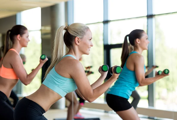 Group of women with dumbbells and steppers — Stock Photo, Image