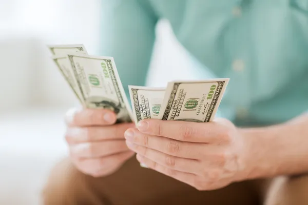 Close up of man counting money at home — Stock Photo, Image