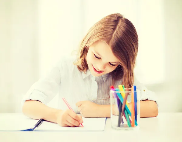 女小的学生在学校在绘制 — 图库照片