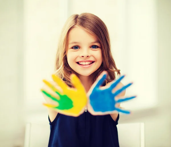 Girl showing painted hands — Stock Photo, Image