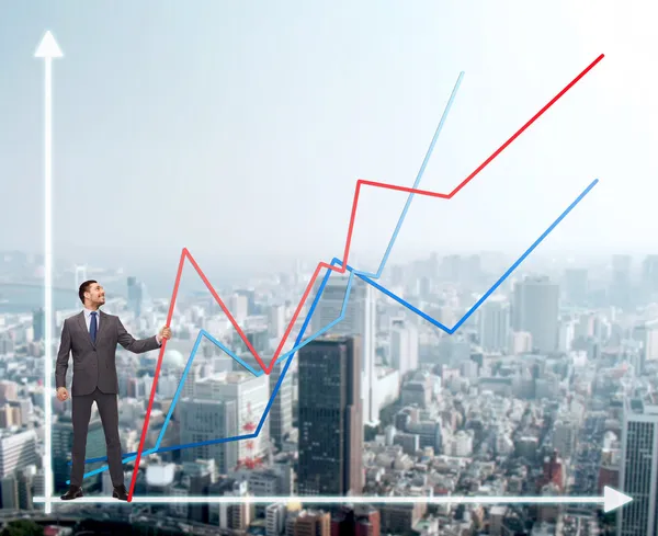 smiling man holding graph line