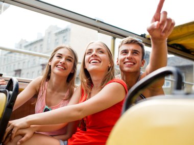 group of smiling friends traveling by tour bus clipart