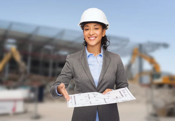 Businesswoman in white helmet with blueprint — Stock Photo, Image