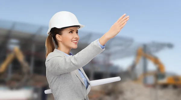 Smiling architect in helmet with blueprint — Stock Photo, Image