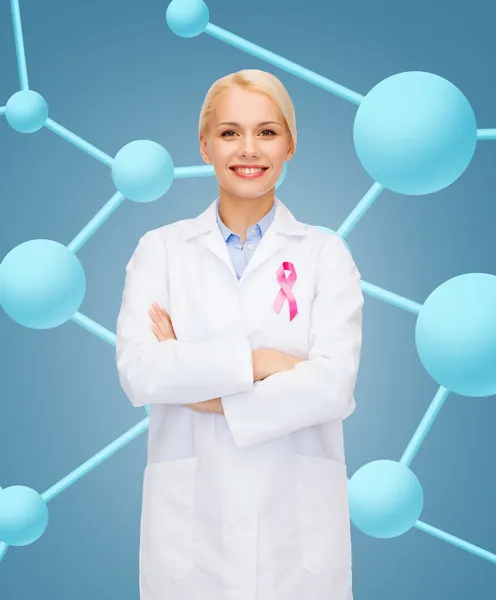 Smiling female doctor with cancer awareness ribbon — Stock Photo, Image