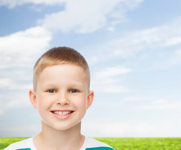 Smiling little boy over natural background — Stock Photo, Image