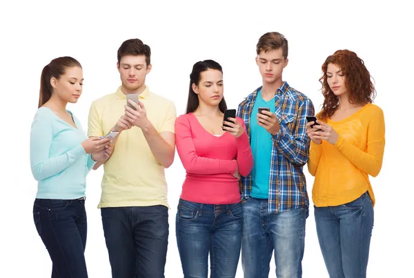 Groupe d'adolescents sérieux avec smartphones — Photo