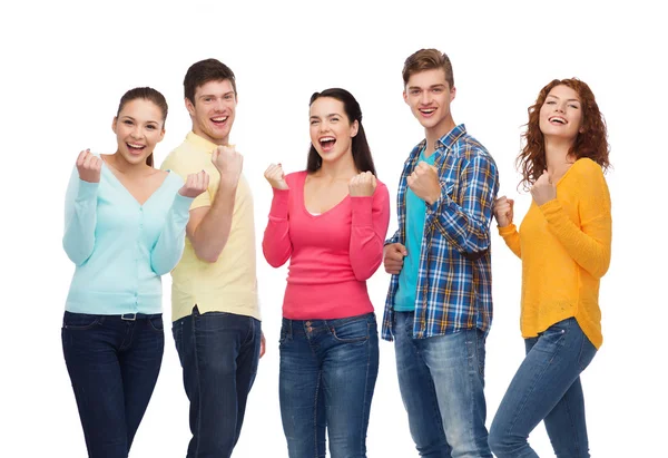 Group of smiling teenagers showing triumph gesture — Stock Photo, Image