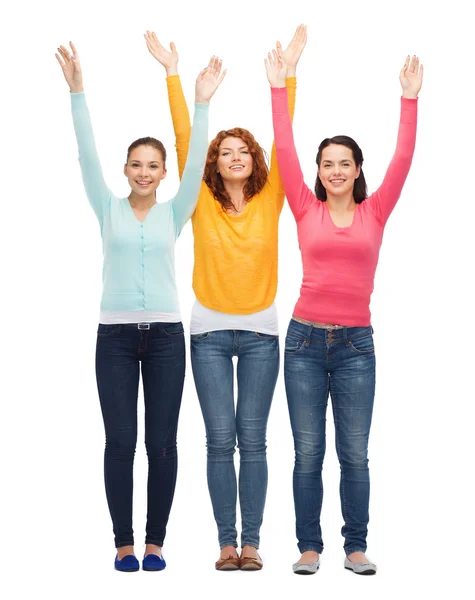 Group of smiling teenagers with raised hands — Stock Photo, Image