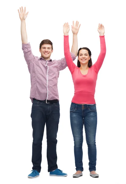 Smiling teenagers with raised hands — Stock Photo, Image