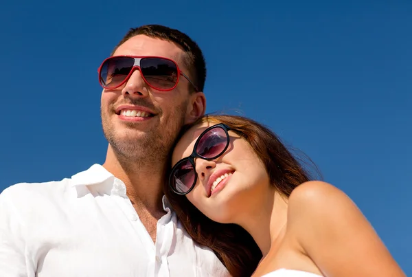 Smiling couple over blue sky background — Stock Photo, Image
