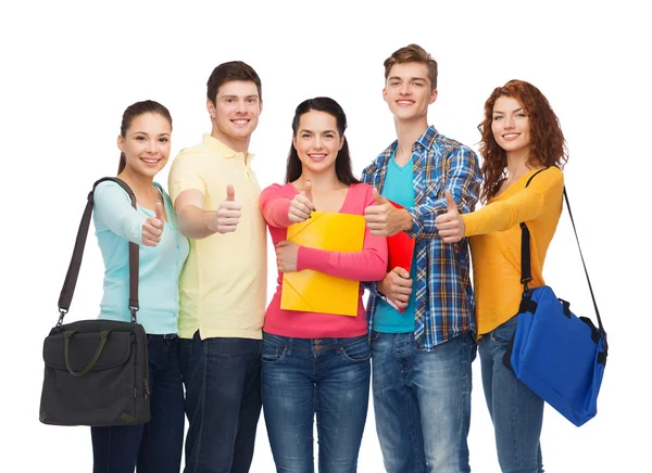 Grupo de adolescentes sorridentes mostrando polegares para cima Imagem De Stock