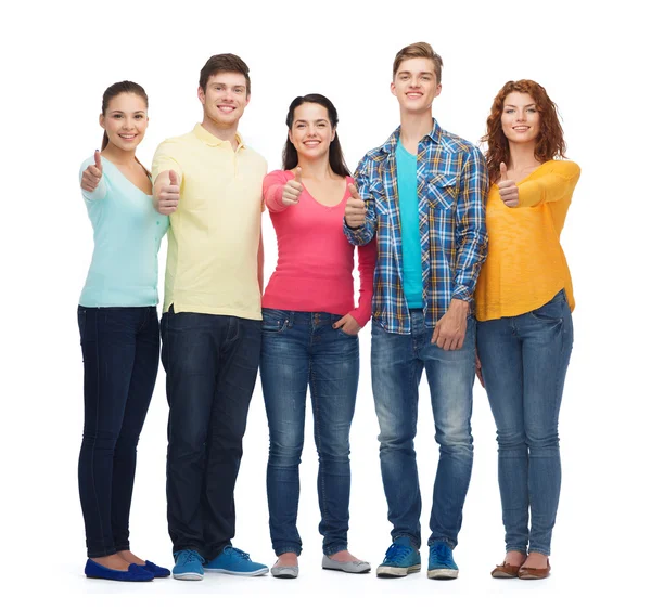 Group of smiling teenagers showing thumbs up Stock Photo