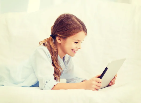 Ragazza sorridente con tablet a casa — Foto Stock