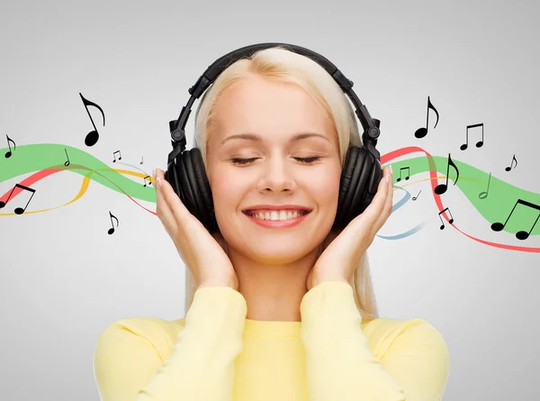 Smiling young woman with headphones — Stock Photo, Image