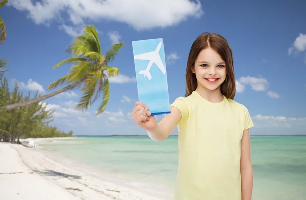 Smiling little girl with airplane ticket — Stock Photo, Image