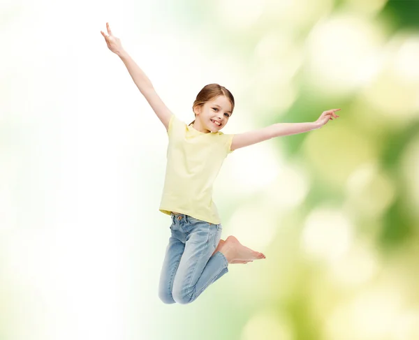 Smiling little girl jumping — Stock Photo, Image