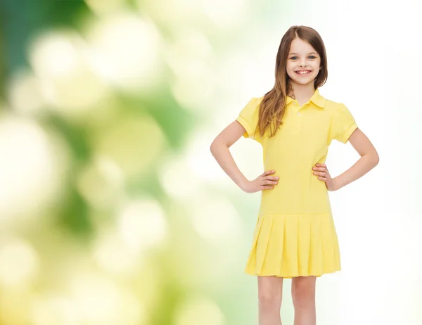 Smiling little girl in yellow dress — Stock Photo, Image