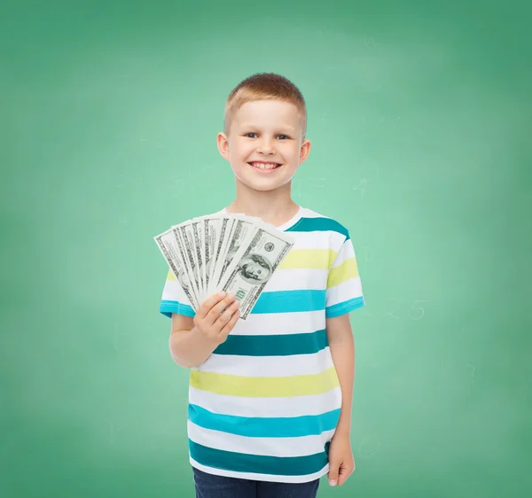 Lachende jongen houdt dollar contant geld in zijn hand — Stockfoto