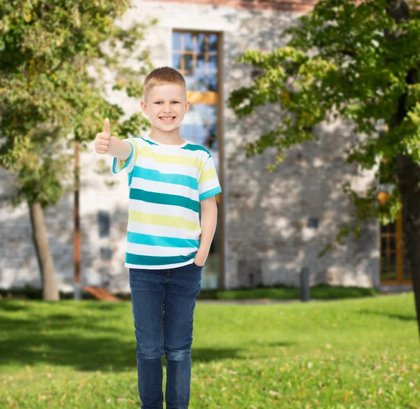 Smiling little boy showing thumbs up — Stock Photo, Image