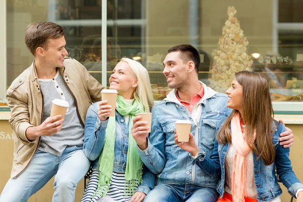 Group of smiling friends with take away coffee — Stock Photo, Image