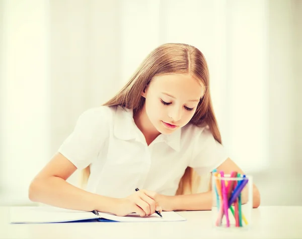 Weinig student meisje tekening op school — Stockfoto