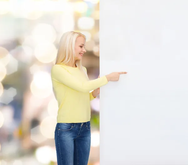 Smiling woman in sweater with blank white board — Stock Photo, Image